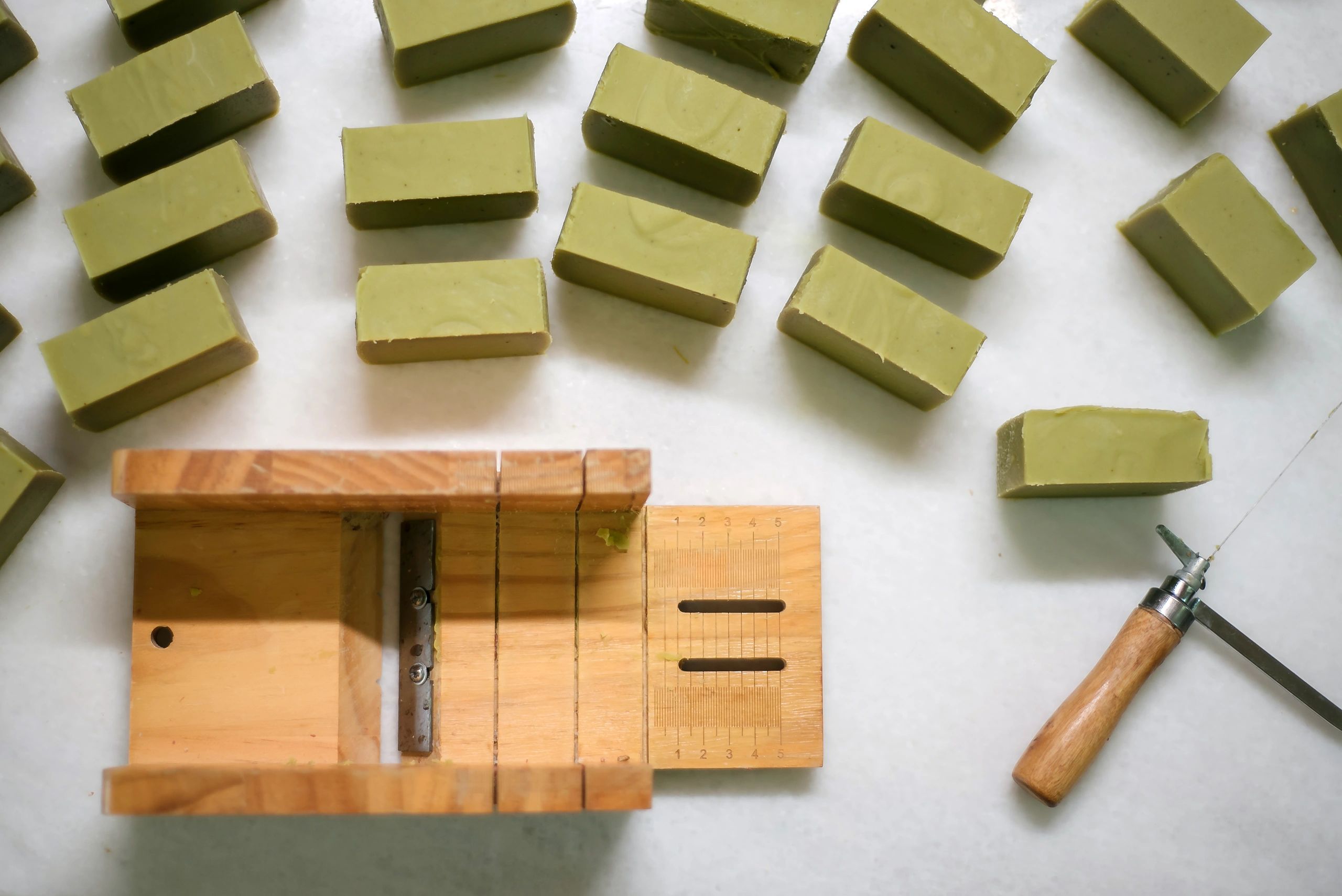 Handmade soap flat lay with soapmaking tools on a table